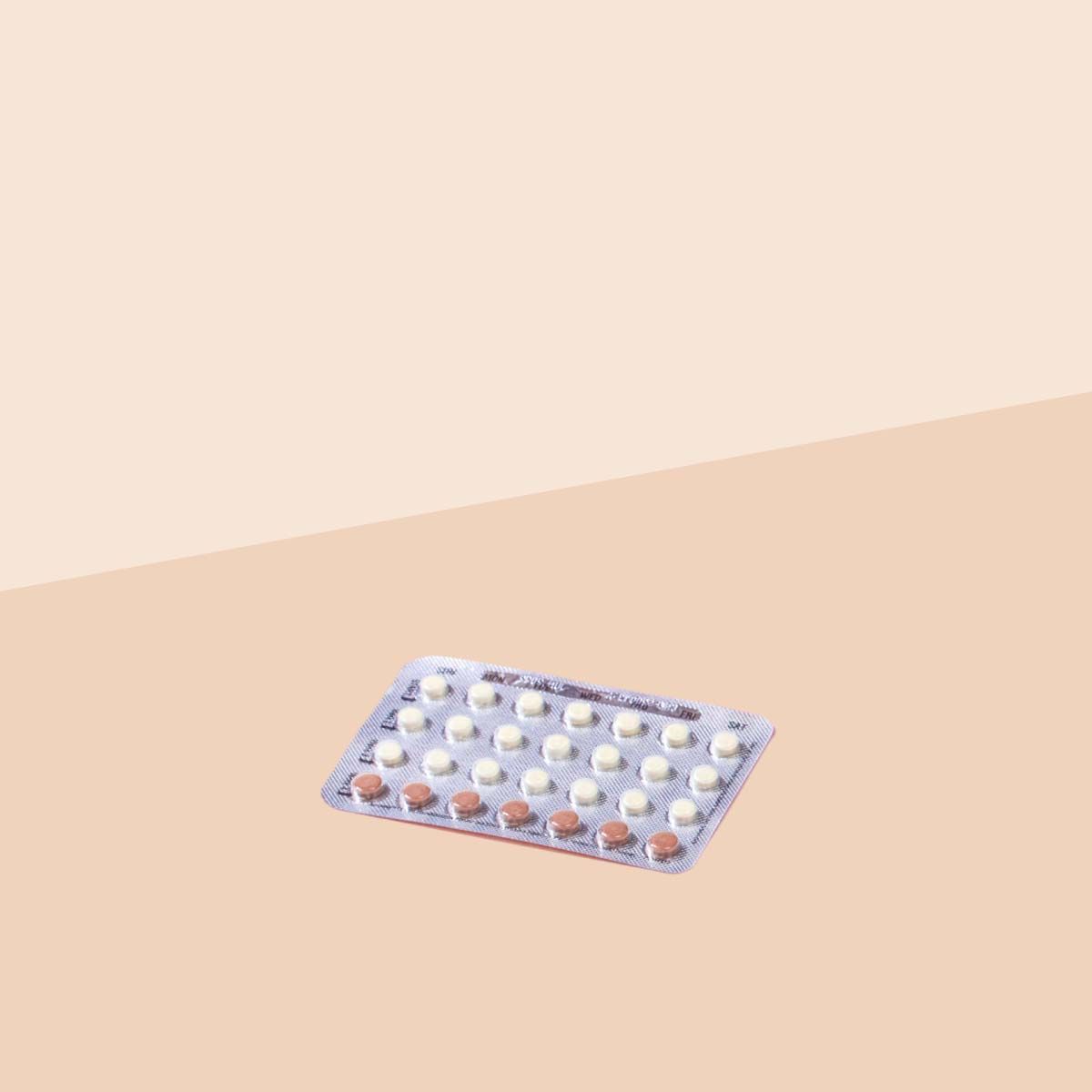 Packet of Trivora birth control pills on a cream surface