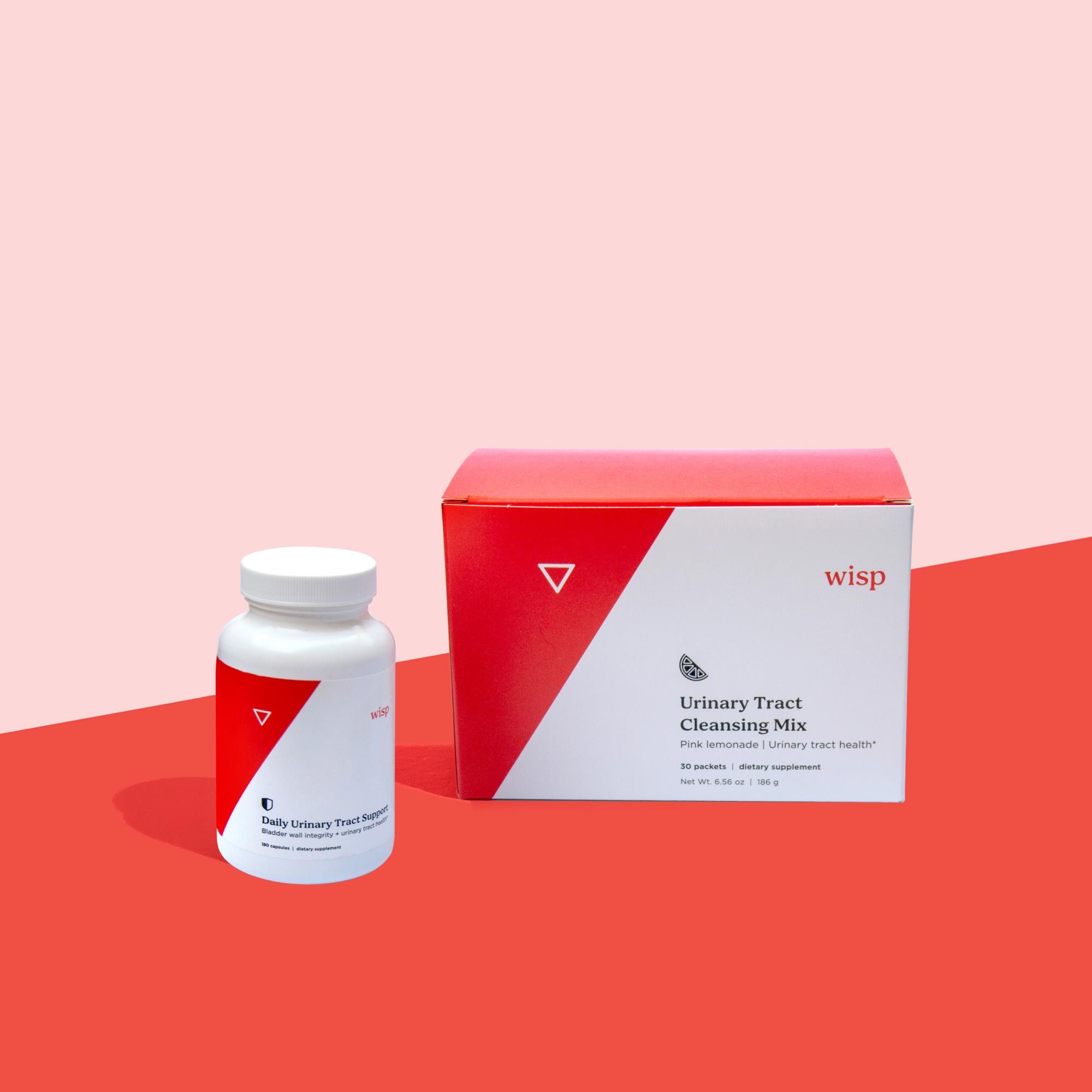 Wisp Urinary Tract Cleansing Mix and Daily Capsules on a red surface with a pink background
