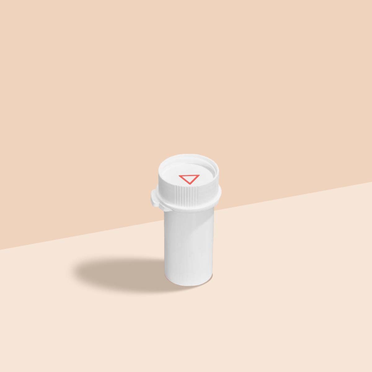 A Wisp pill vial on a cream surface