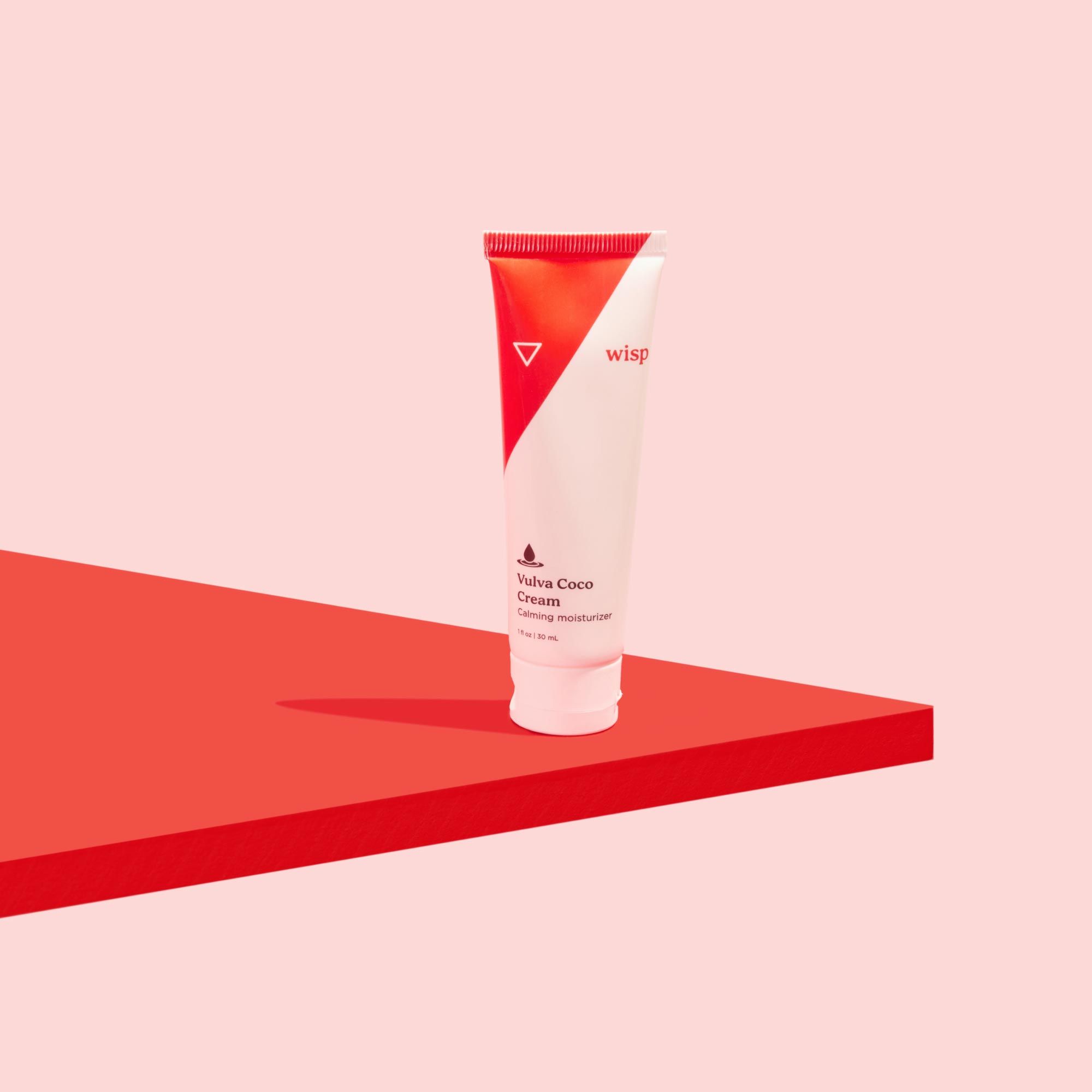 Wisp Vulva Coco Cream on a red surface with a pink background