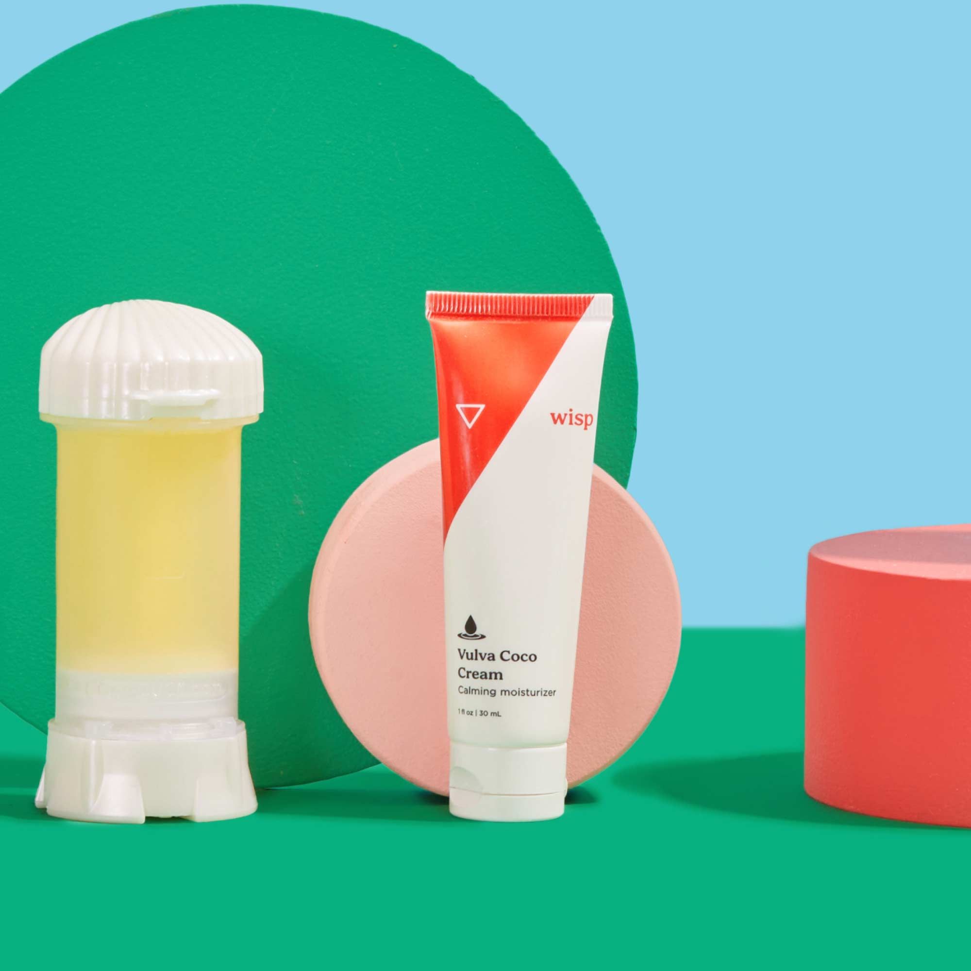 Vulva Coco Cream and Non-Hormonal Vaginal Moisturizer with colorful abstract shapes on a green surface with a light blue background