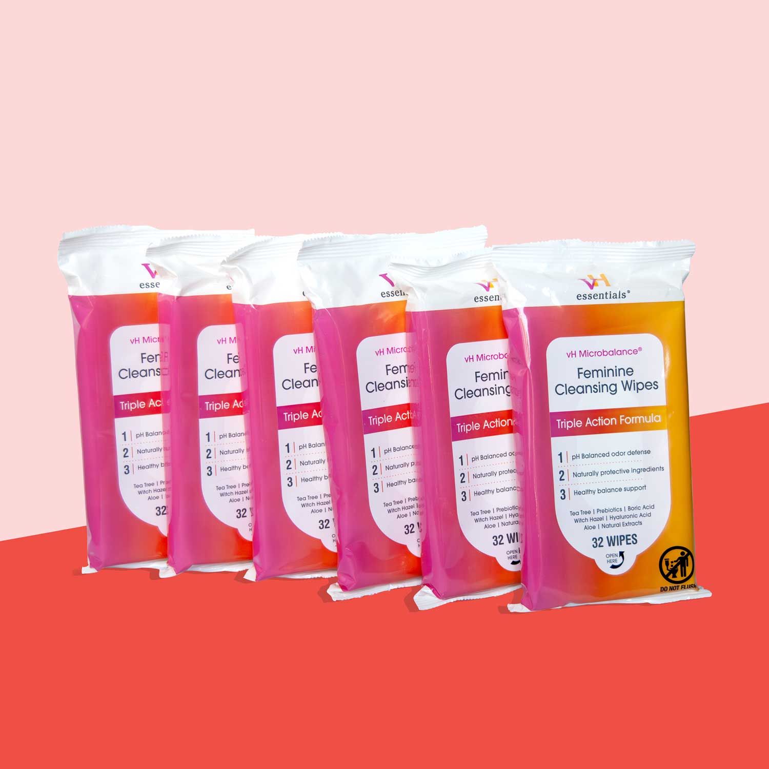 6 packages of pH Balancing Wipes on a red surface with a pink background