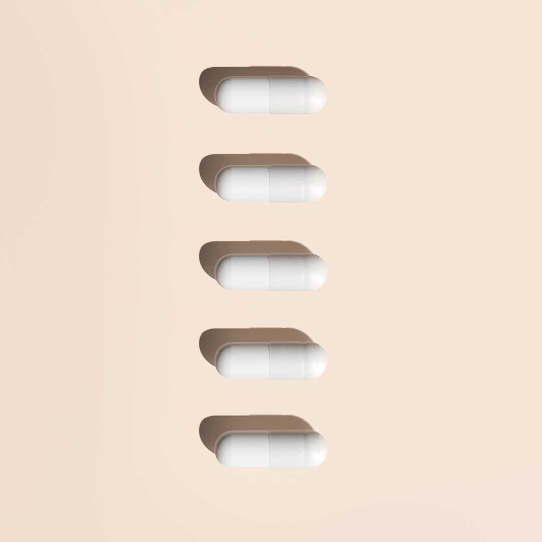 5 D-Mannose pills on a cream surface