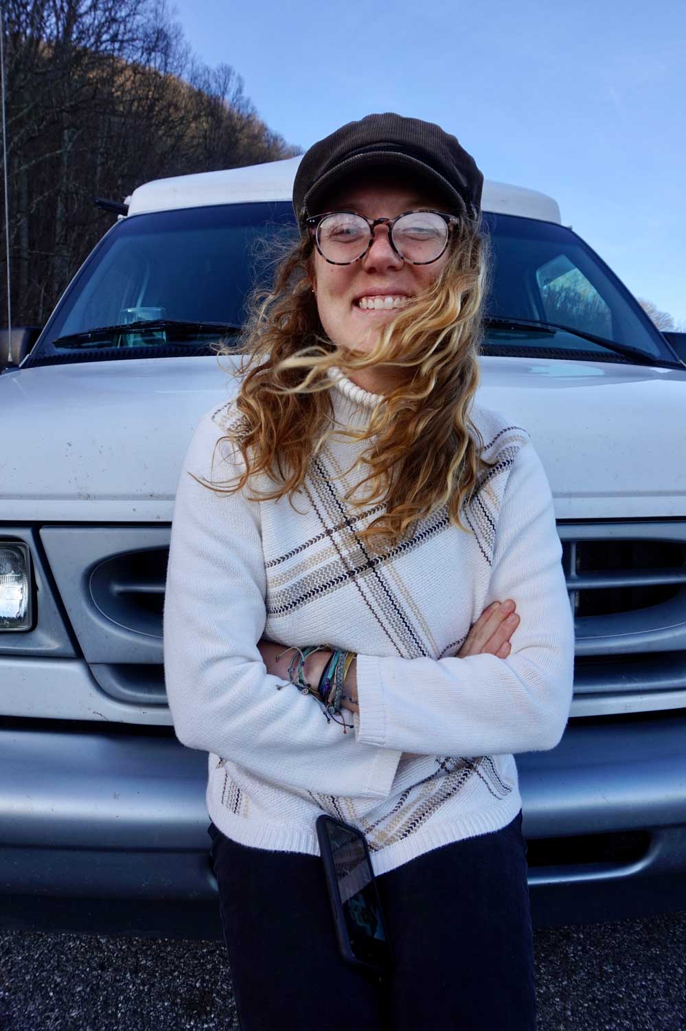 Image of Courtney Stephenson in front of her camper van in the mountains