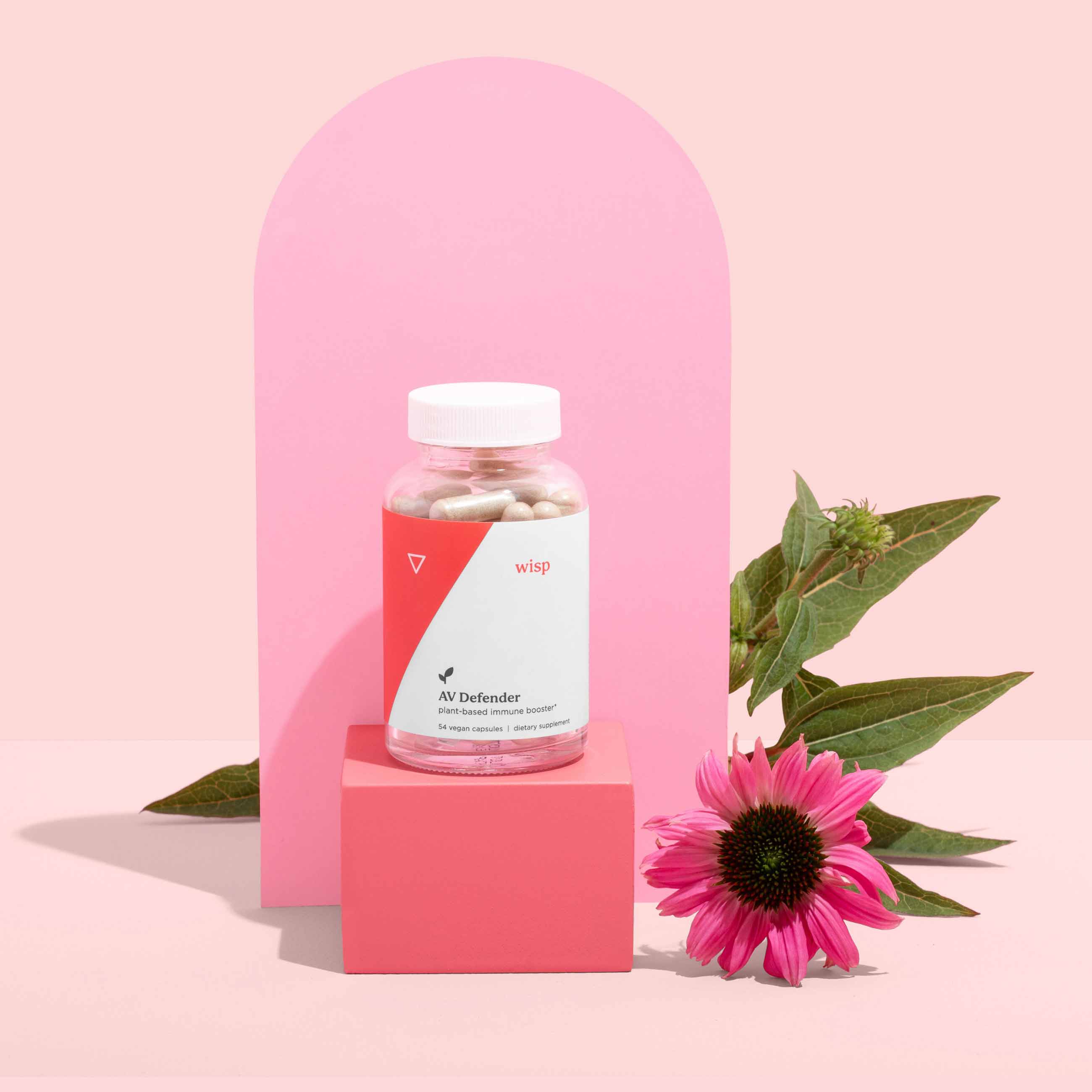 Bottle of AV Defender and florals on a pink background