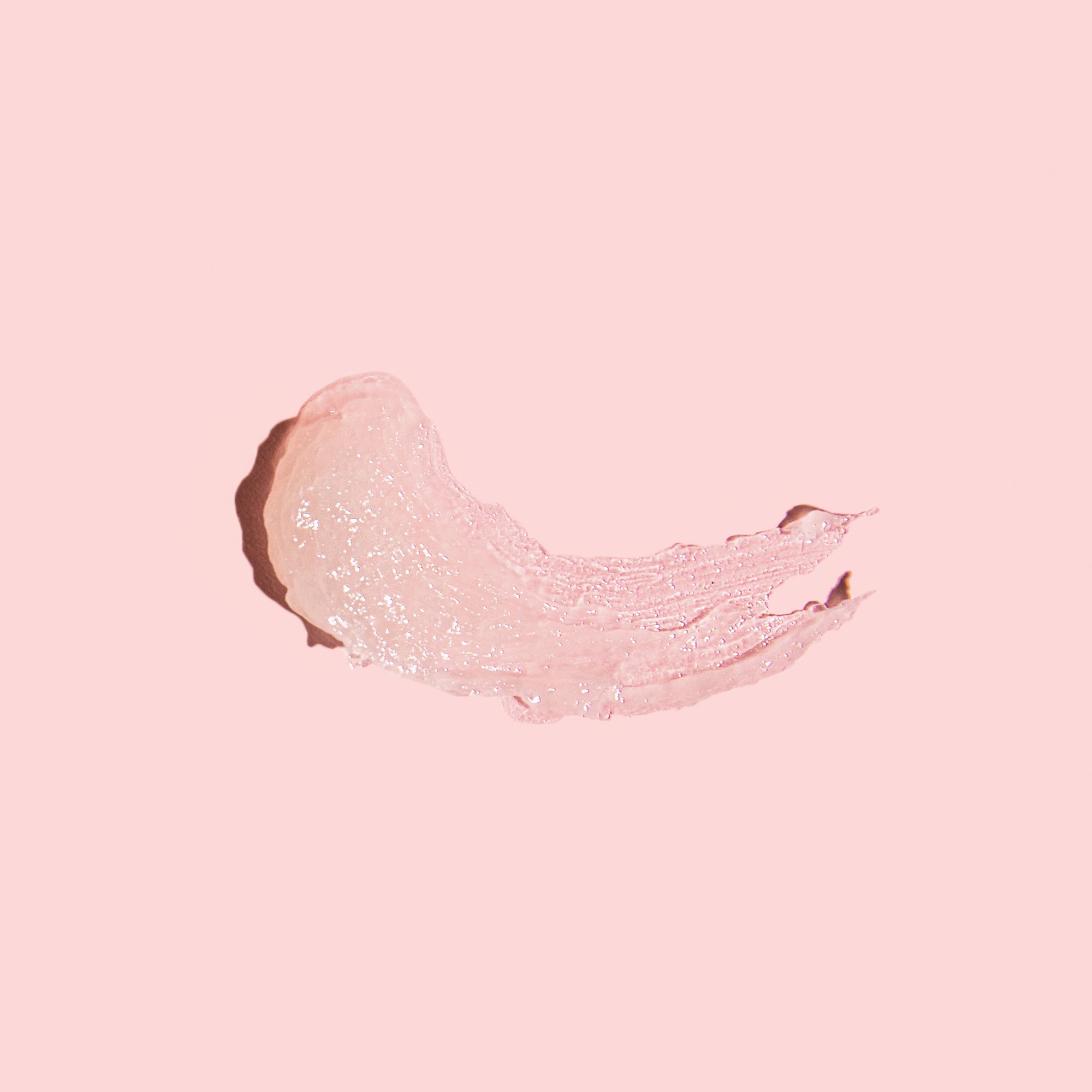 Smear of Acyclovir cream to treat oral and genital herpes on a pink background
