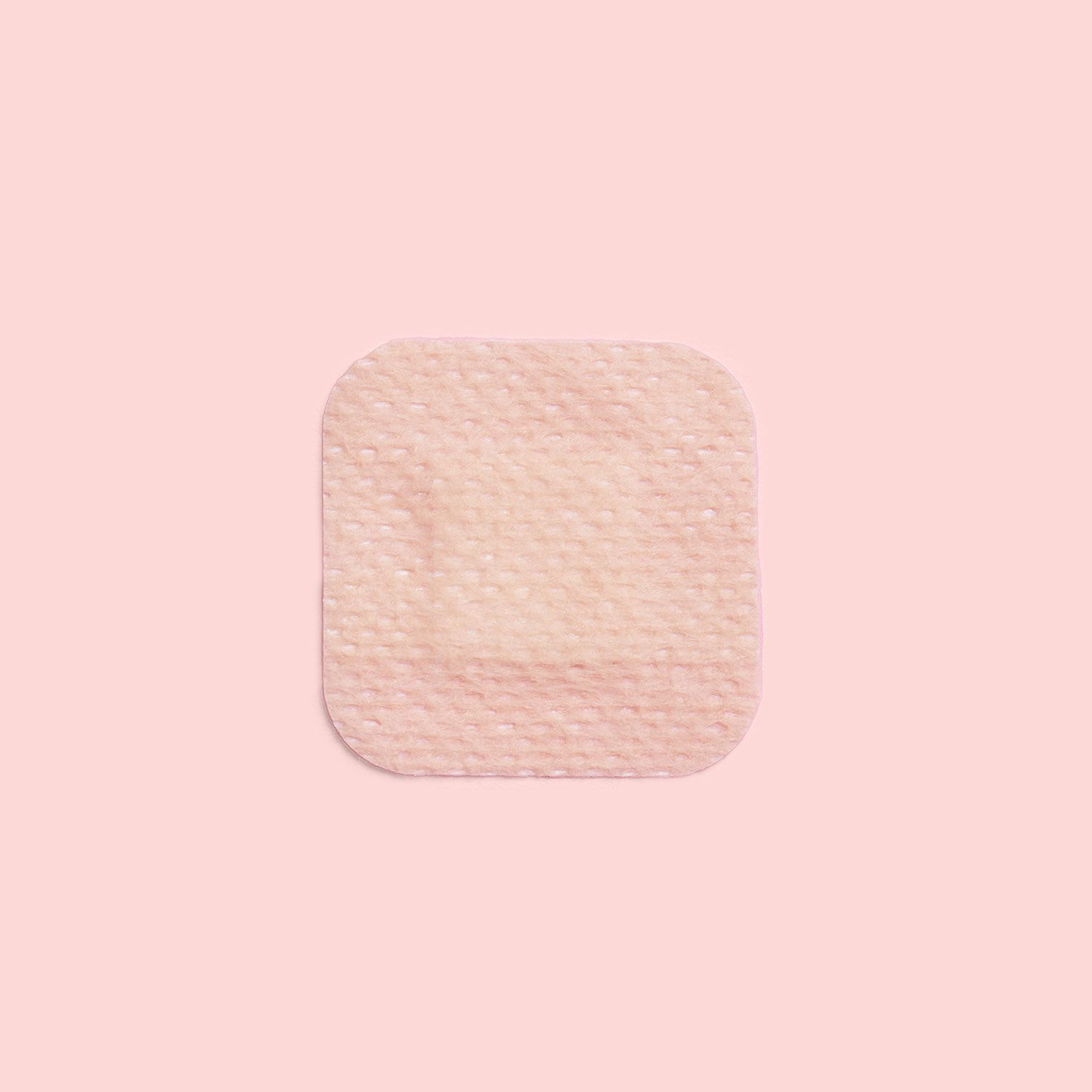 a birth control patch on a pink background