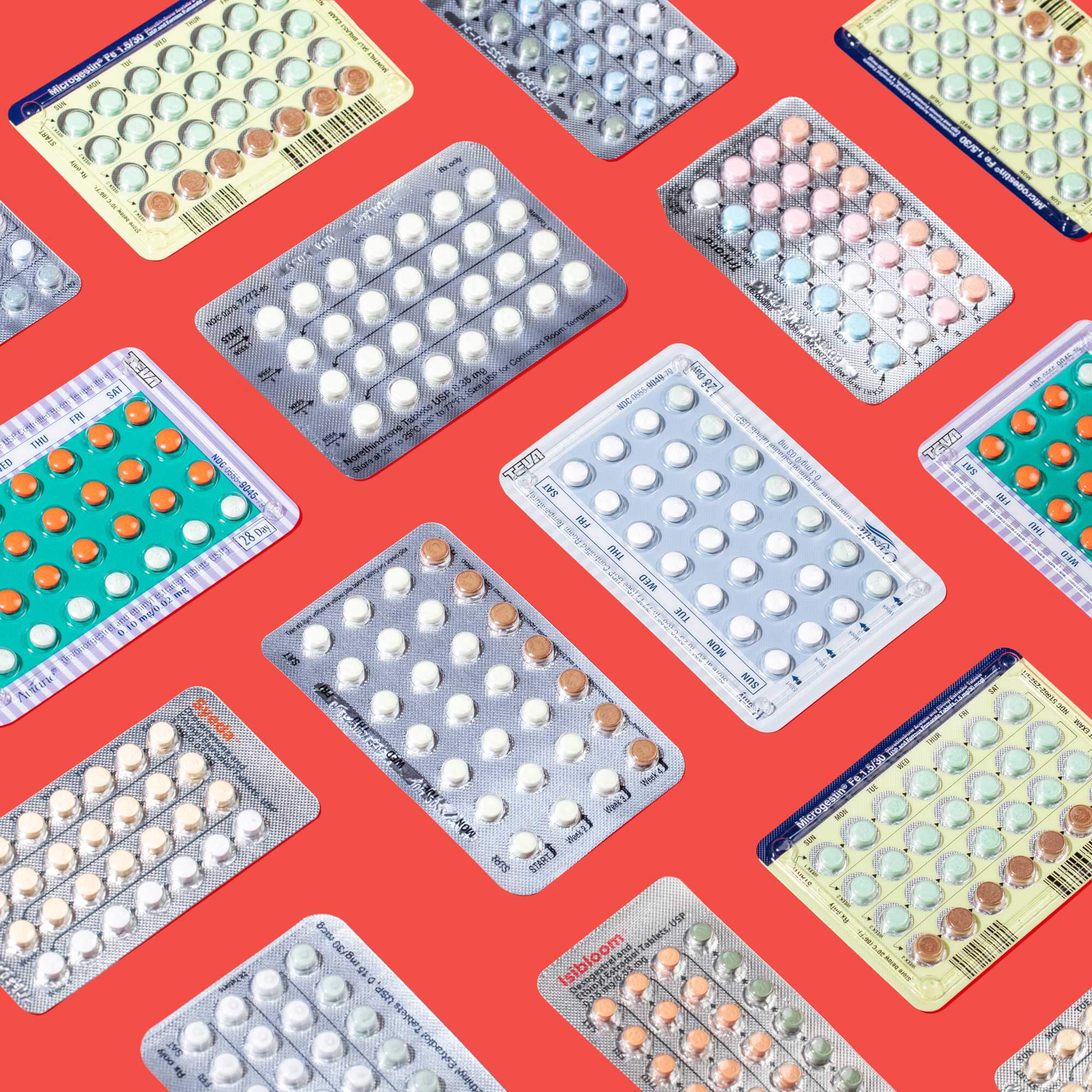 Several colorful birth control packets on a red background