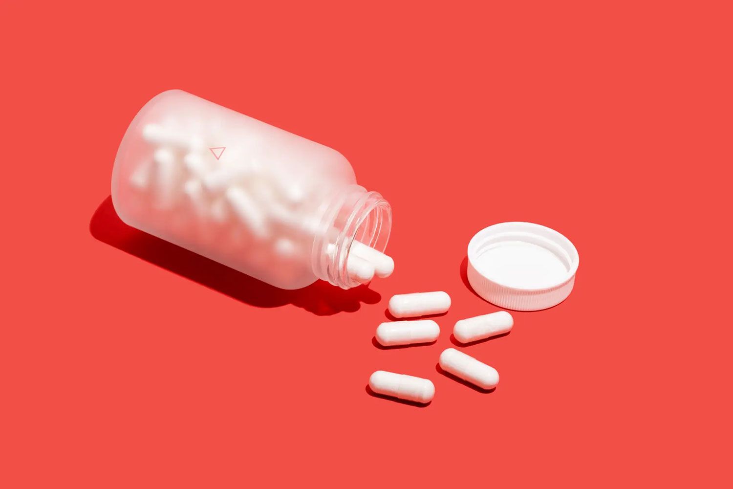 Open Wisp jar of pills on a red background