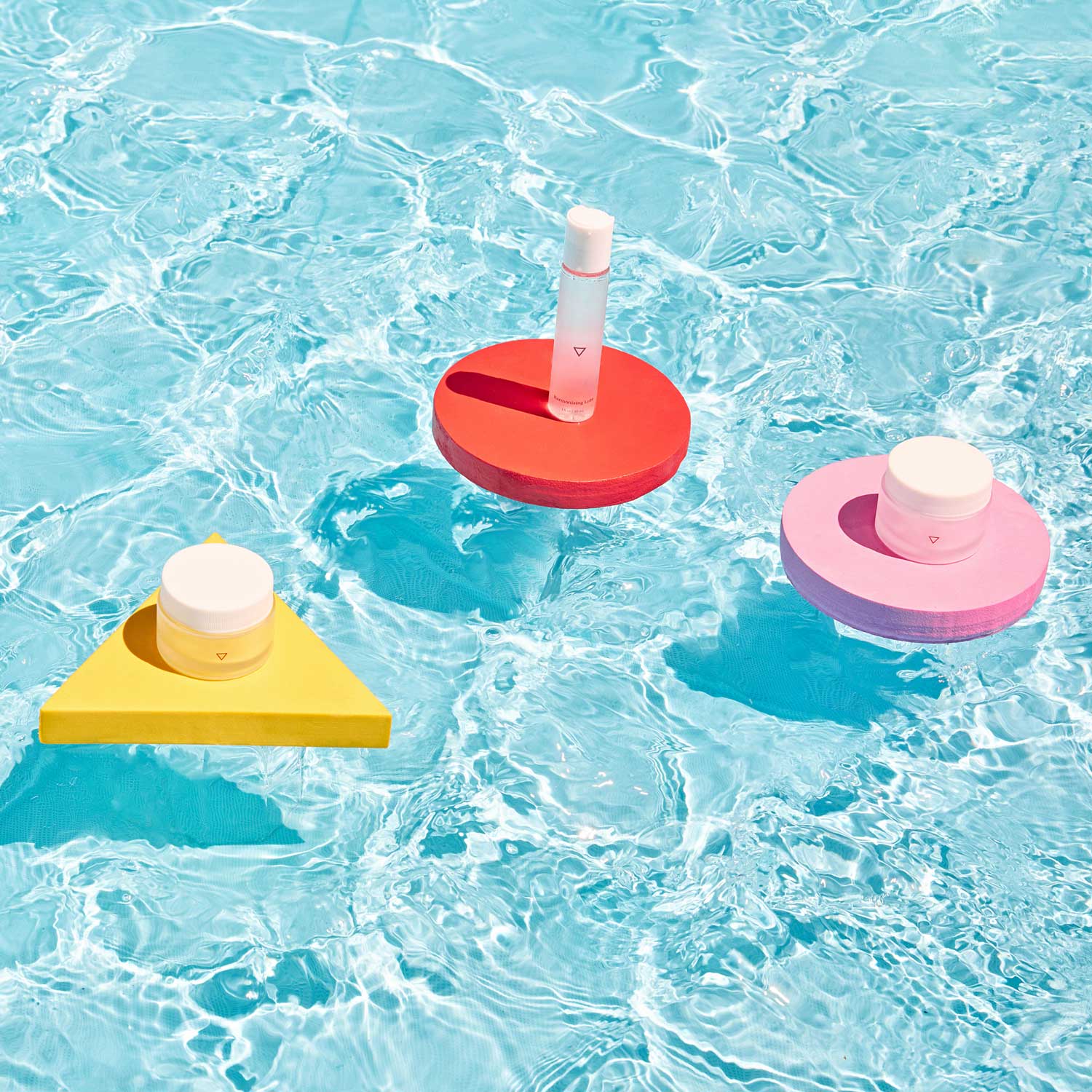 Medication floating in pool on colorful geometric shapes