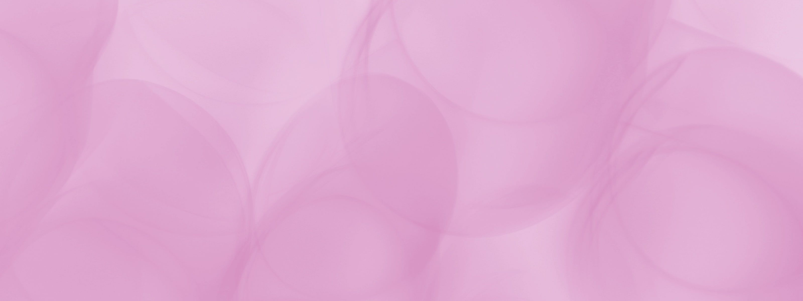 Soft abstract background with overlapping translucent pink and mauve shapes.