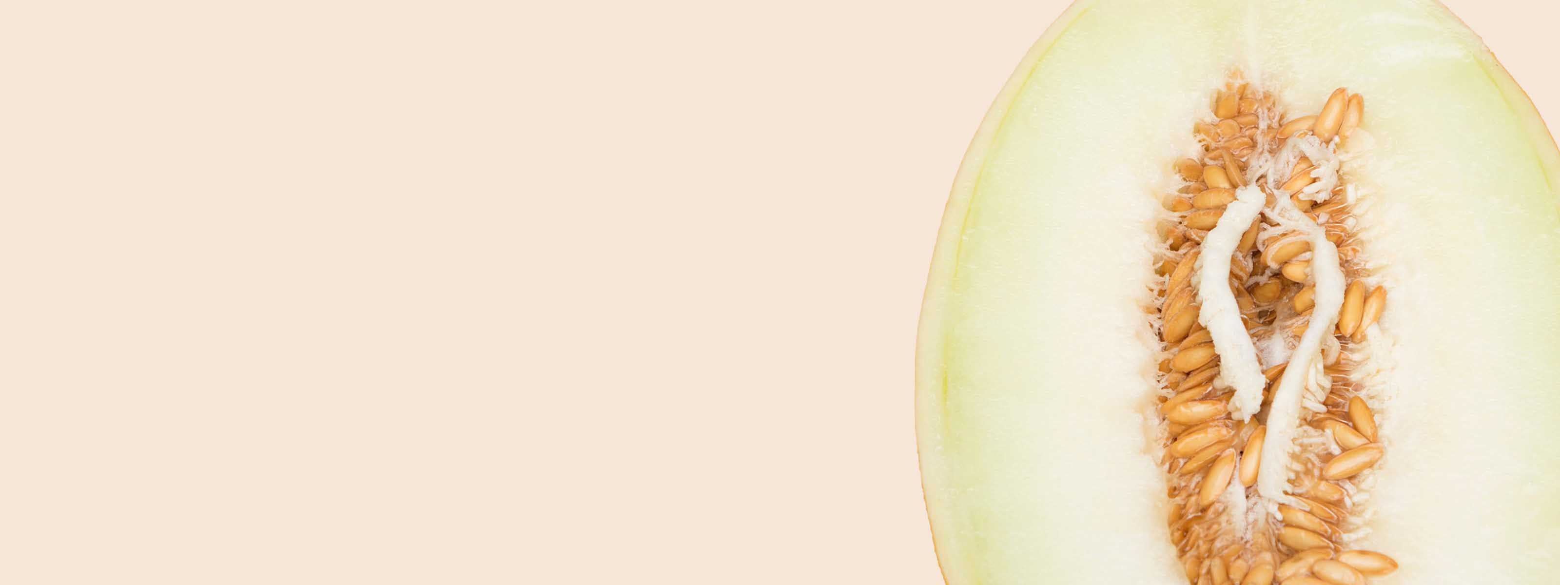 A cut open melon on a yellow background