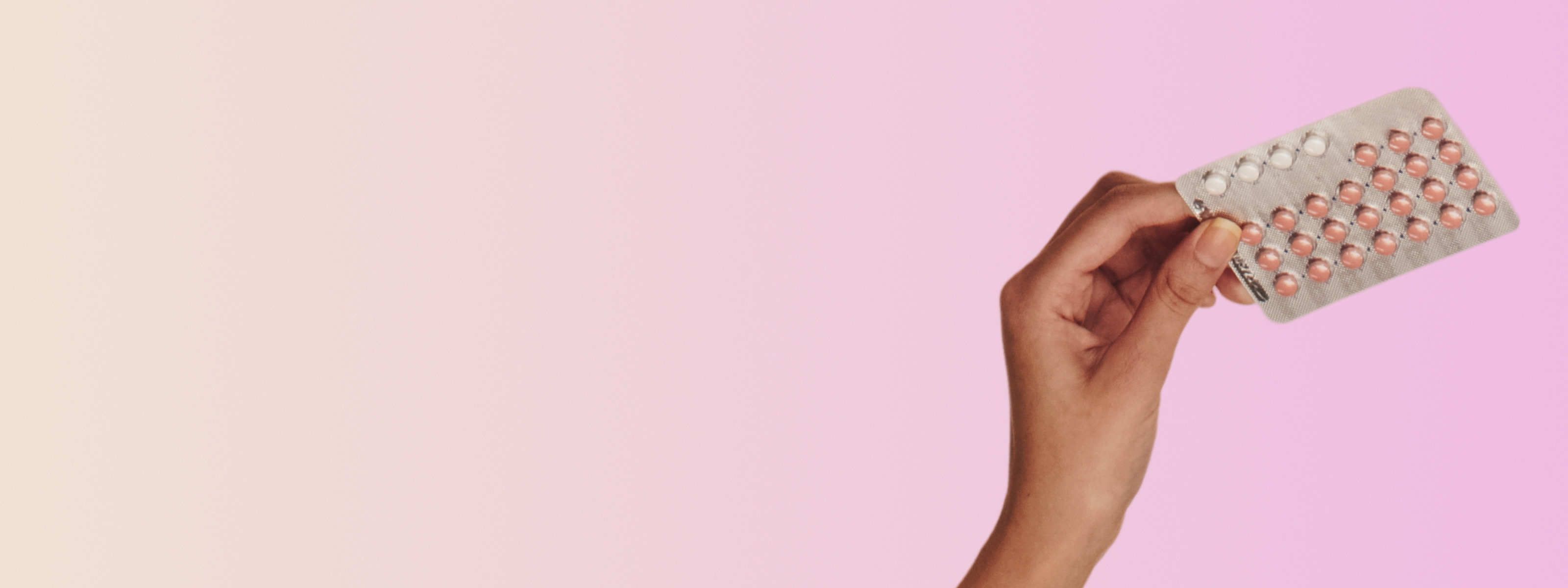 woman holding azurette birth control pack in front of light pink background