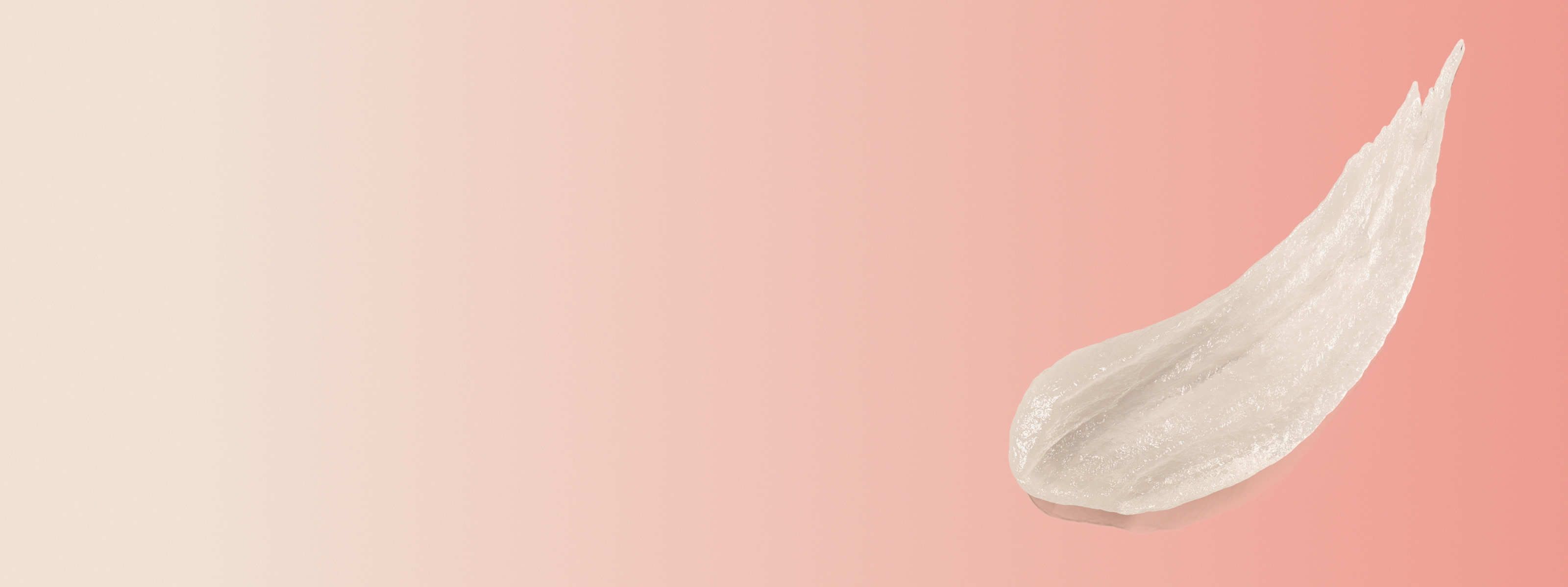 swipe of metronidazole gel in front of a red and beige background
