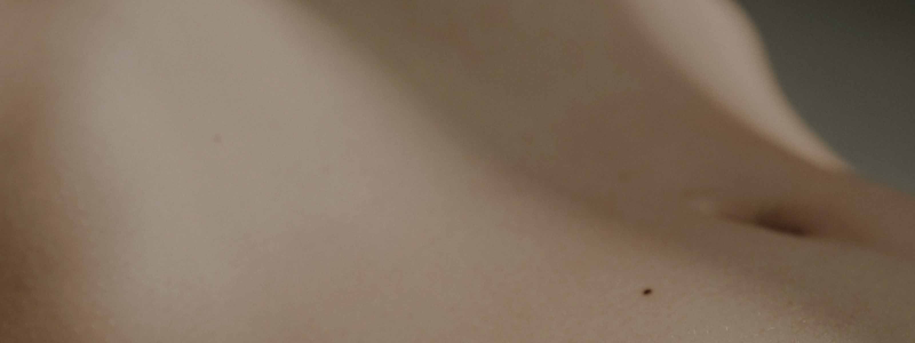 An image of a person's abdomen with moody lighting