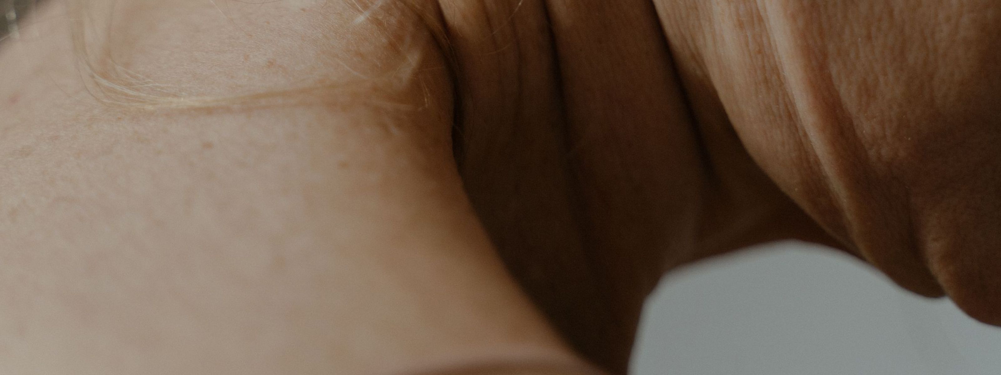 image of a womans neck with a strand of hair