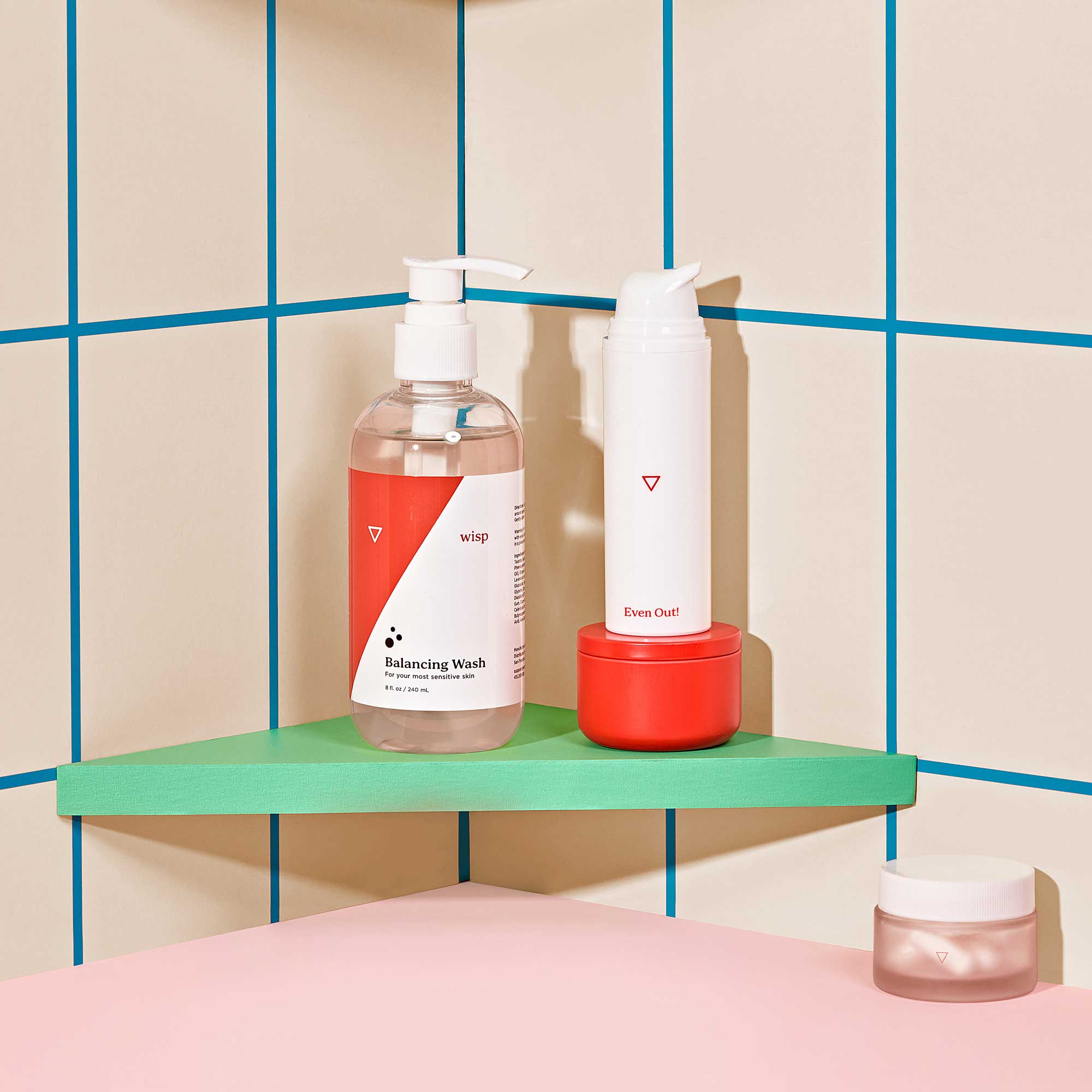 Wisp Balancing Wash, Hydroquinone Cream, and pill bottle in shower with colorful background