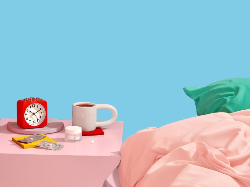 Emergency contraception and reproductive health medication sits on nightstand next to coffee and alarm clock