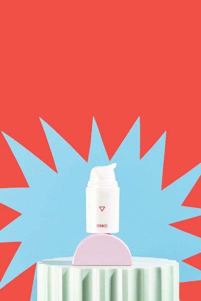 A bottle of OMG! Cream sits on colorful abstract shapes with a blue starburst pattern and a red background