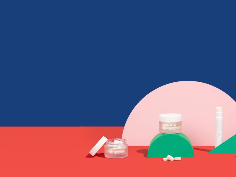 Various Wisp vaginal health medications sit on colorful geometric background