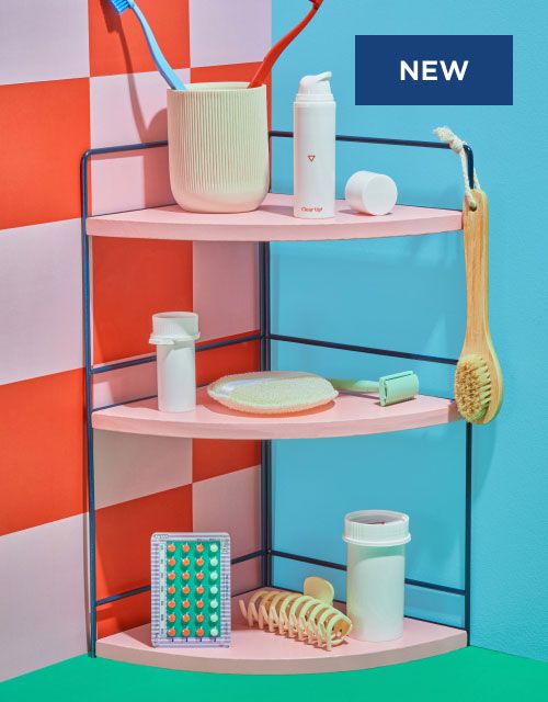 Various Wisp products paired with bathroom routine products on a pink shelf