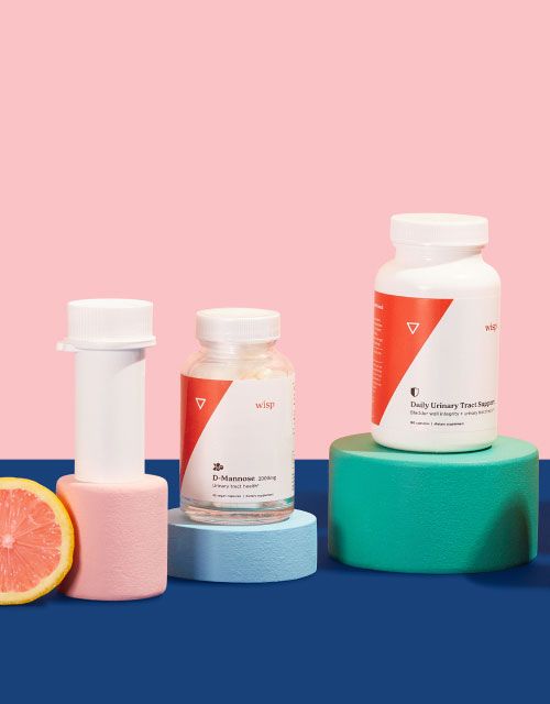 Wisp's UTI category balanced on colorful abstract shapes on a blue surface with a pink background