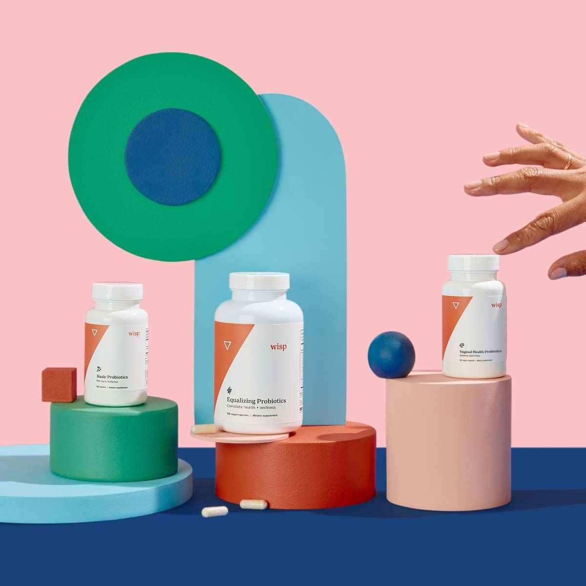 Wisp, Basic Probiotics, Equalizing Probiotics, and Vaginal Probiotics on colorful abstract shapes on a blue surface with a pink background