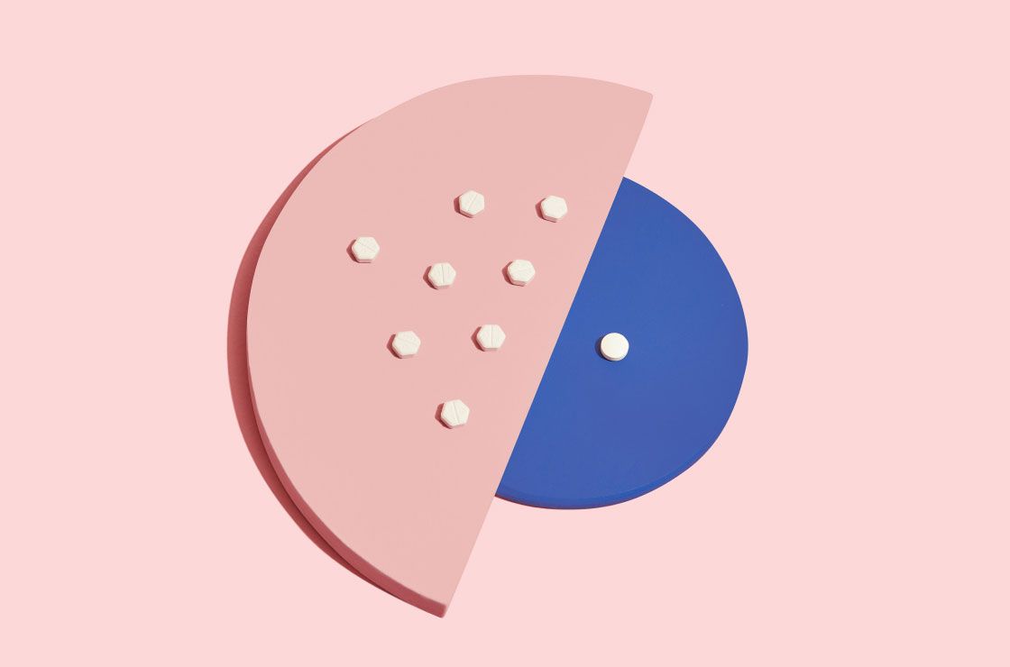 Medication Abortion pills on colorful abstract shapes with a pink background