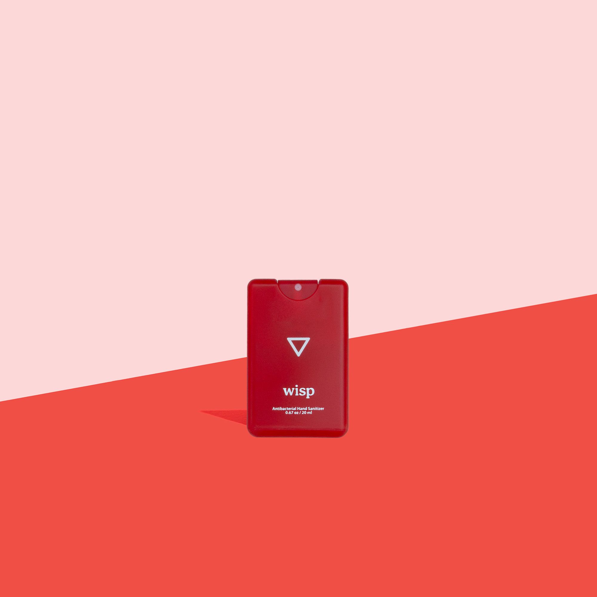 Wisp Pocket Hand Sanitizer on pink and red background