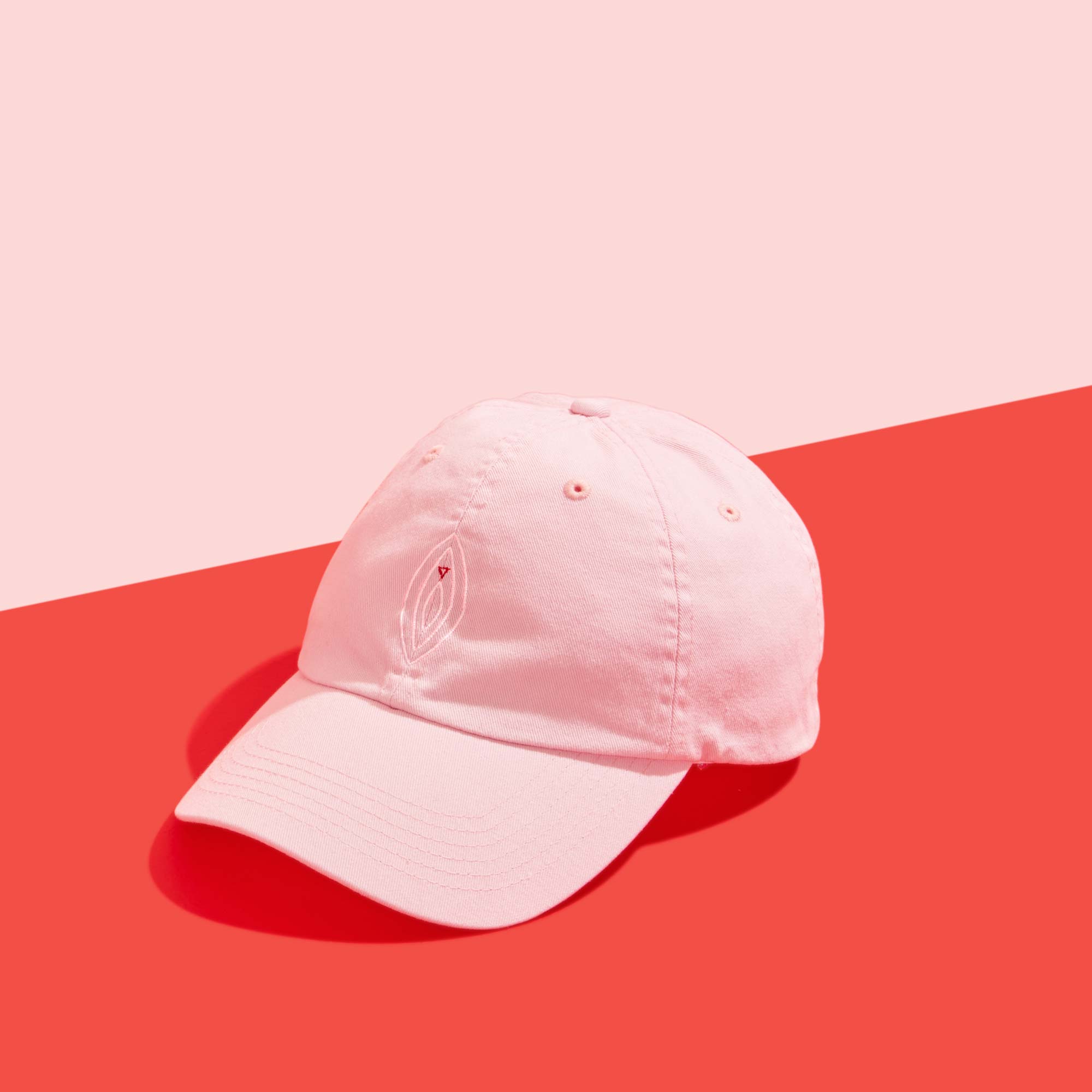 Wisp vulva hat on a pink and red background