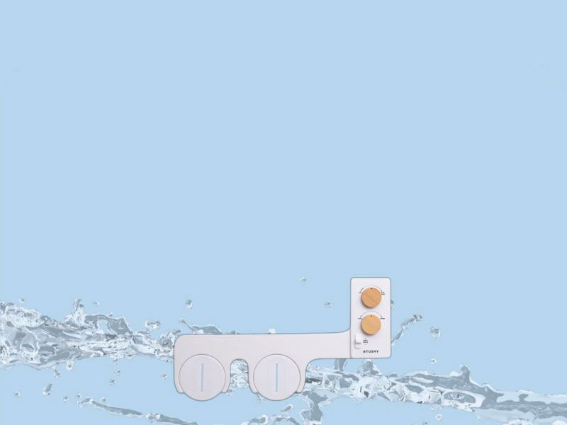 Tushy Bidet connected to a toilet with a light blue background