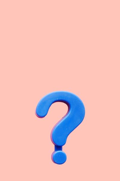 A purple question mark on a peach-colored background