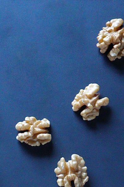 walnuts scattered on a blue surface