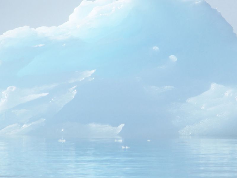 An iceburg floating on water