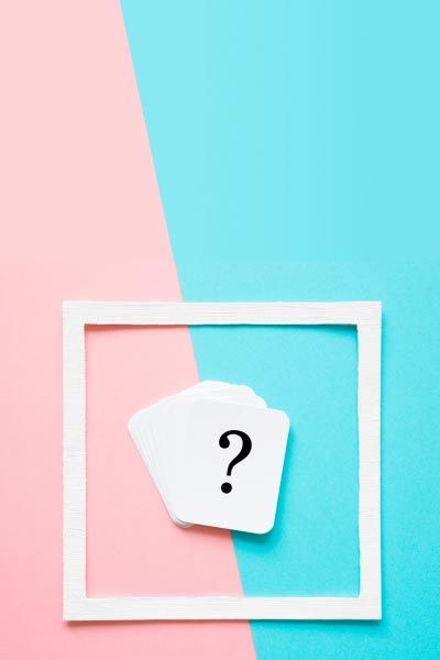 A question mark inside a white frame on a pink and light blue background