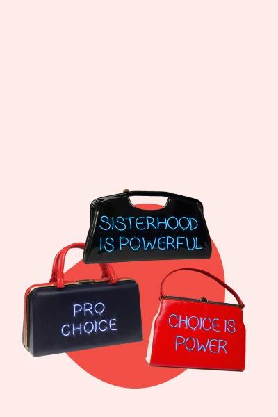 3 Michele Pred handmade purses with abortion rights statements on them on a red and cream-colored background