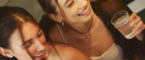 A group of smiling women at a social event