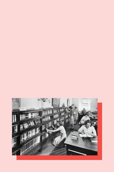 A black and white image of women studying in a library