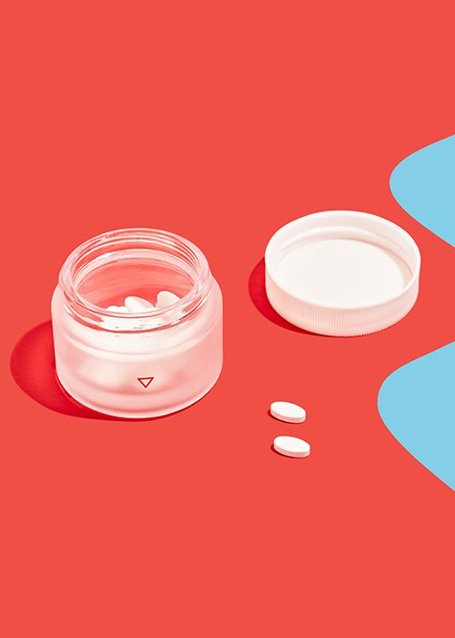 Norethindrone acetate to delay your period in a glass jar on a red and blue background