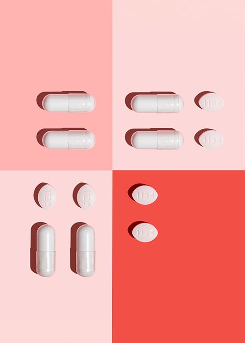 various vaginal health pills sitting on a geometric pink and red background