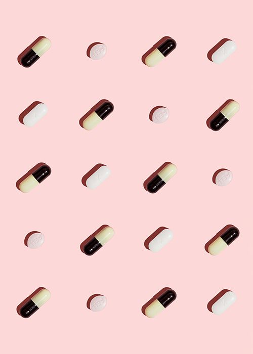Antibiotics pills to treat UTI on a pink background
