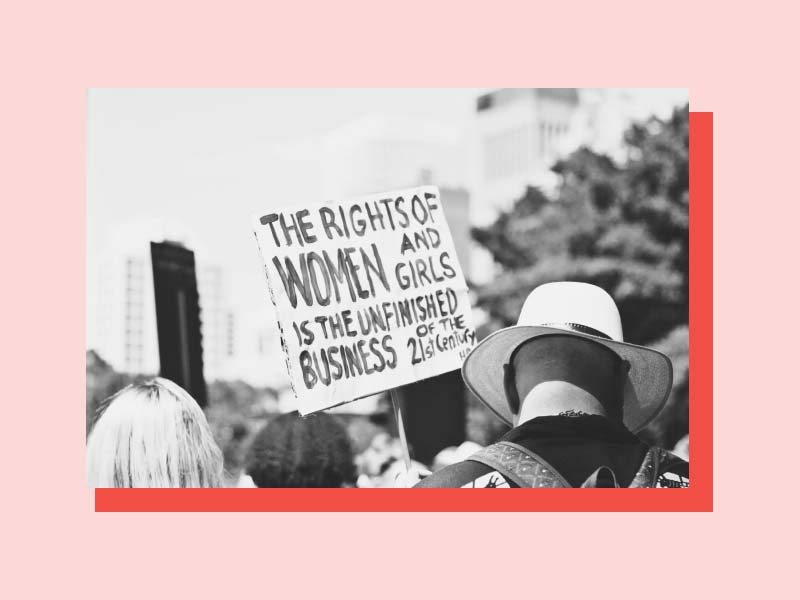 A black and white image of a women's rights protest sign
