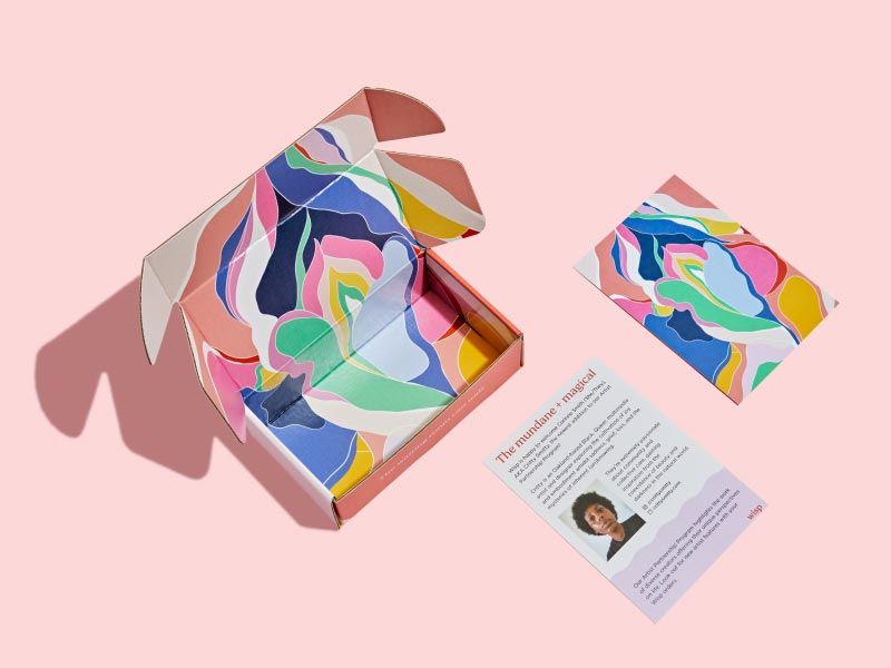 Image of a Wisp Box with a featured artist design on the inside on a pink background