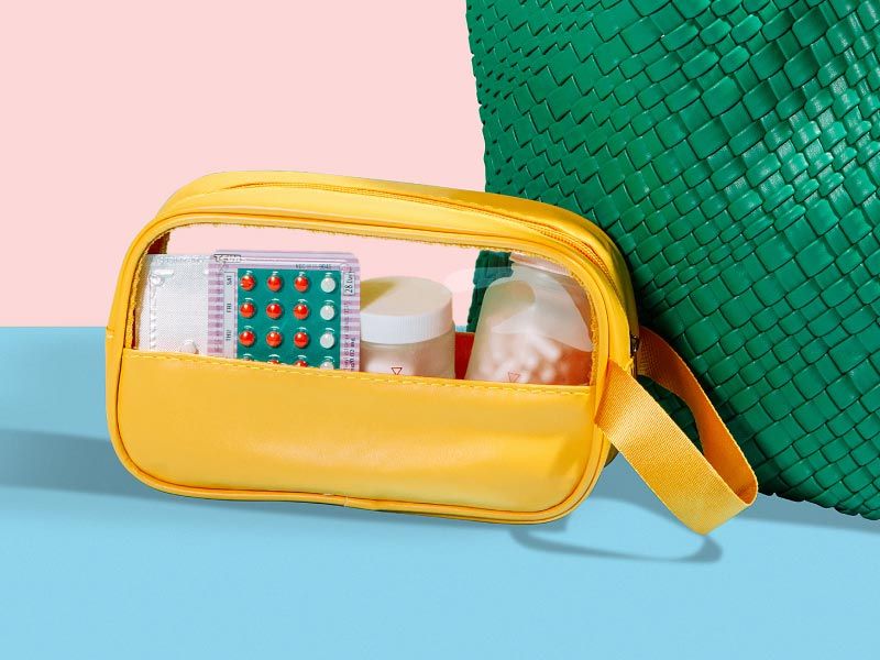 A yellow travel pouch with Birth Control packet and other Wisp medications on a pink and light blue background