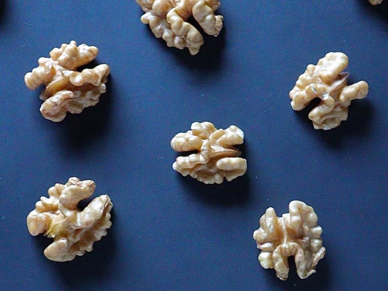 walnuts scattered on a blue surface