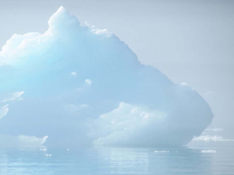 An iceburg floating on water
