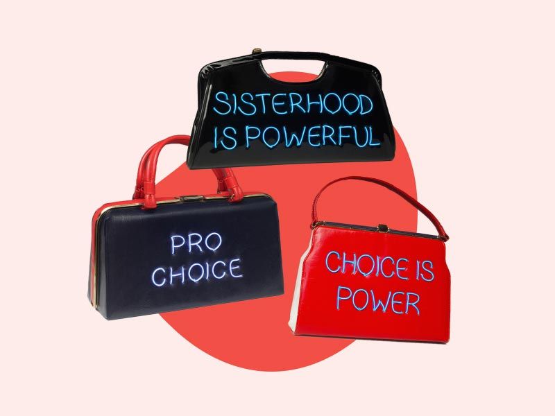 3 Michele Pred handmade purses with abortion rights statements on them on a red and cream-colored background