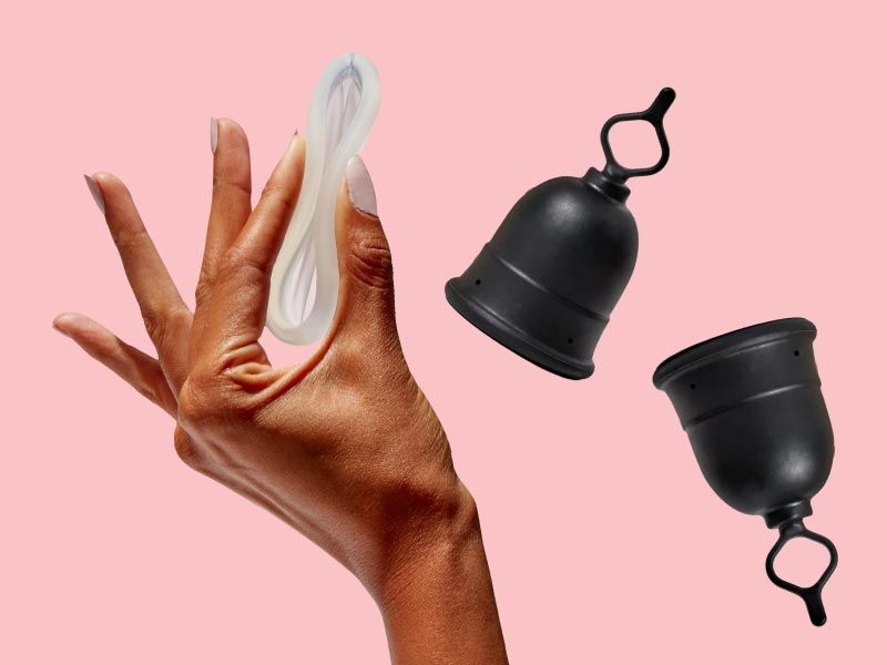 A woman's hand holding the Flex Disc next two two Flex Menstrual Cups with a pink background