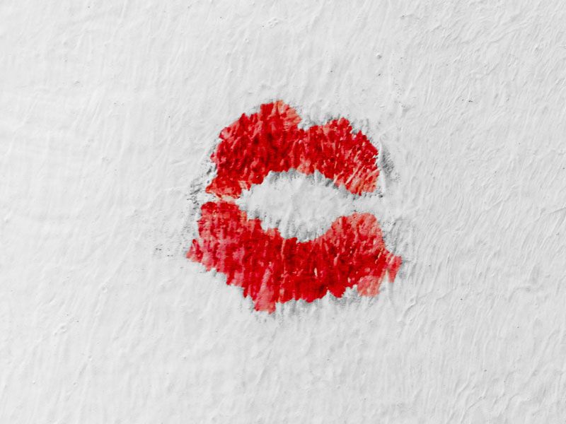 Red lipstick kiss on a white wall