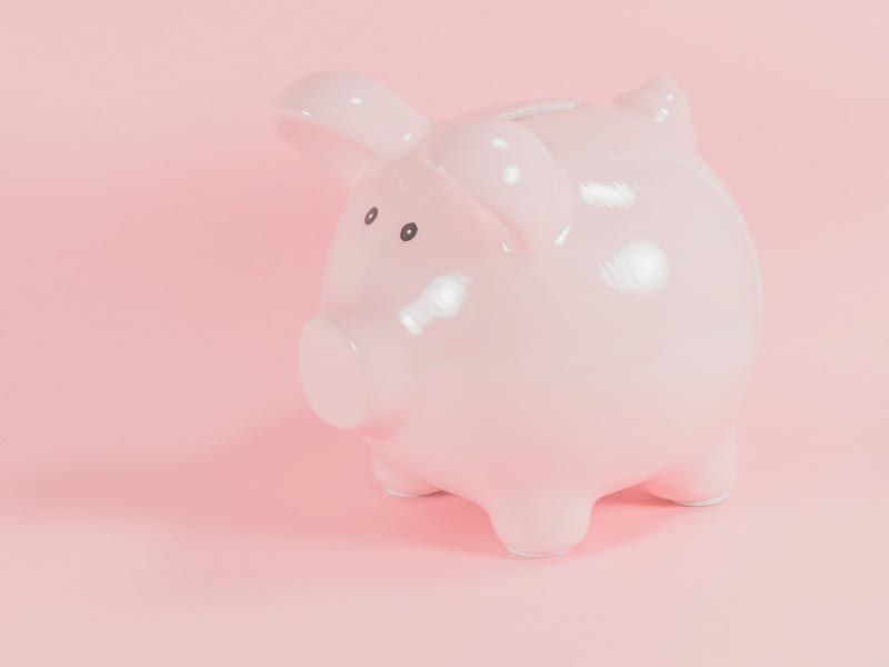 A pink piggy bank with a pink background
